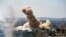 In this photo released by the Syrian official news agency SANA, smoke rises after Syrian government airstrikes and shelling hit in Hajar al-Aswad neighborhood held by Islamic State militants, southern Damascus, April 22, 2018.