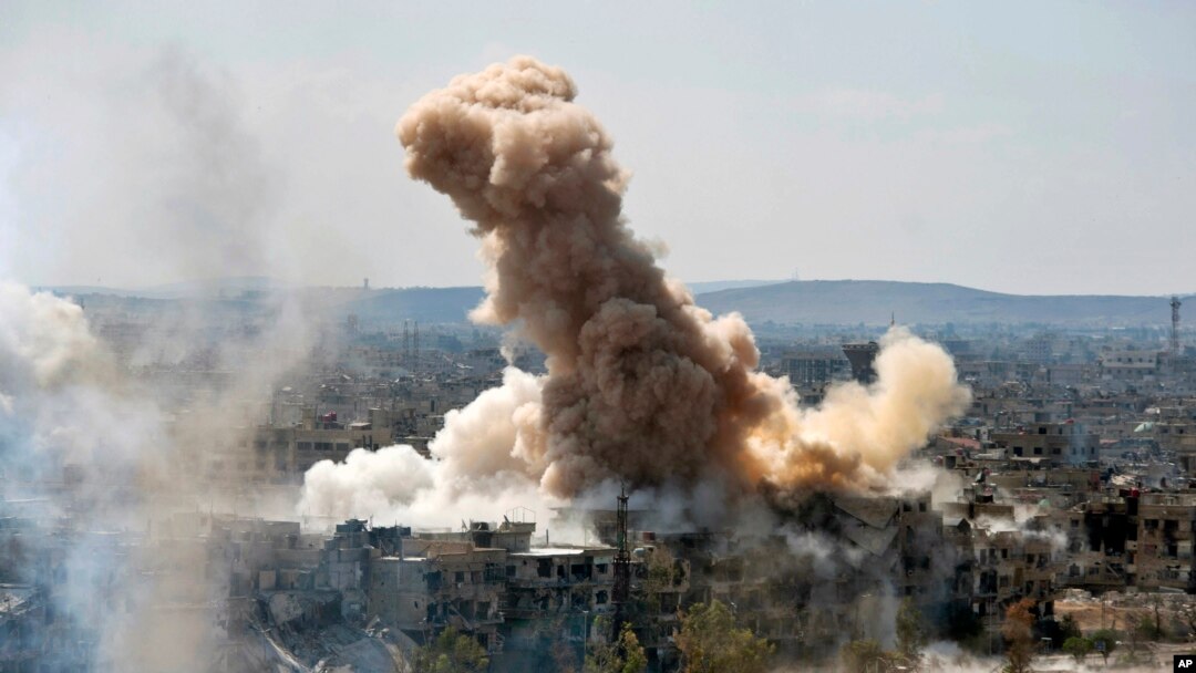 FILE - In this photo released by the Syrian official news agency SANA, smoke rises after Syrian government airstrikes and shelling hit in Hajar al-Aswad neighborhood held by Islamic State militants, southern Damascus, April 22, 2018.