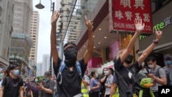 Les manifestants font un geste de cinq doigts, signifiant les "cinq exigences - pas une de moins", lors d'une manifestation pro-démocratique contre la législation de Pékin sur la sécurité nationale à Hong Kong, le dimanche 24 mai 2020. (Photo AP)
