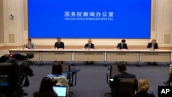 FILE - Chinese academics and government officials attend a press conference at the State Council Information Office in Beijing, March 24, 2021. China's Education Ministry has required universities to submit academic articles that journals have retracted over the past three years.