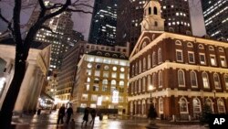 Faneuil Hall, right, is seen at night in Boston. Faneuil Hall is one of the historic sites on Boston's Freedom Trail.