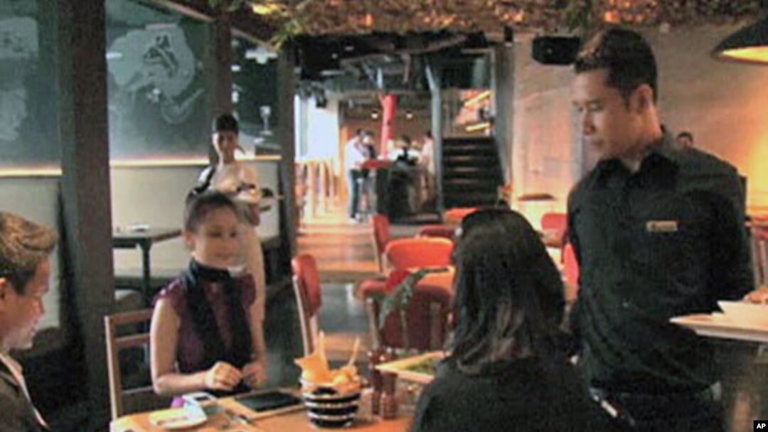 Diners enjoy a meal at the newly-opened Smoking Joe's Barbecue and Lounge, which serves genuine American barbecue, in Jakarta, Indonesia, May 2011