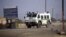 A police vehicle is parked outside the Marikana platinum mine, where police opened fire on hundreds of workers staging a wildcat strike on August 16 that has left 44 dead, August 21, 2012. 