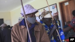 A couple wait for the COVID-19 vaccine at the Butanda Health Centre III in Western Uganda, April 27, 2021. 