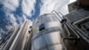 FILE - A liquid carbon dioxide containment unit stands outside the fabrication building of Glenwood Mason Supply Company, April 18, 2023, in the Brooklyn borough of New York.