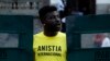 FILE - An Amnesty International activist shouts slogans in Rio de Janeiro, Brazil, April 1, 2014.