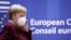 Germany's Chancellor Angela Merkel, wearing a face mask, speaks on the phone as she attends a two-day face-to-face EU summit, in Brussels, Belgium October 16, 2020. Kenzo Tribouillard/Pool via REUTERS