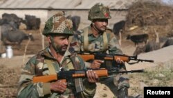 FILE - Indian army soldiers stand guard near the Indian Air Force (IAF) base at Pathankot in Punjab, India, Jan. 3, 2016. India's government has disciplined NDTV Hindi channel for related coverage, drawing media protest.