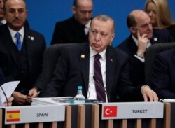 FILE - Turkish President Recep Tayyip Erdogan participates in a round table meeting during a NATO leaders meeting at The Grove hotel and resort in Watford, Hertfordshire, England, Dec. 4, 2019.