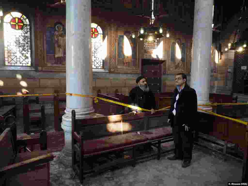 Priests and curate check the attacked church &ldquo;Botrosia&rdquo; following a blast in Cairo, Dec. 11, 2016.