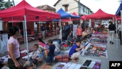 Handicraft and souvenir vendors wait for customers and tourists at the night market of Luang Prabang, October 18, 2009.