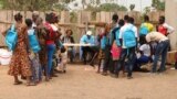 FILE — South Sudanese children line up to receive school materials and other supplies in Yambio, on February 12, 2019.