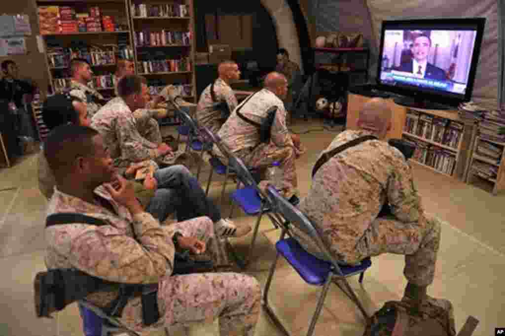 U.S. Marines of Regiment Combat Team 1 watch TV as President Barack Obama announces the death of Osama bin Laden, at Camp Dwyer in Helman Province, Afghanistan, May 2, 2011