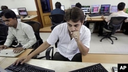 A stock broker watches the Bombay Stock Exchange (BSE) index on his trading terminal in Mumbai, India, Aug. 8, 2011.