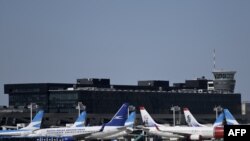 FILE - Commercial aircrafts remain at the tarmac of Jorge Newbery airport, which is closed during the outbreak of the new coronavirus, COVID-19, in Buenos Aires, Argentina, March 20, 2020. 