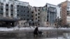 A woman walks past a building damaged by a Russian military strike, amid Russia's attack on Ukraine, in the town of Pokrovsk in Donetsk region, Ukraine, Dec. 12, 2024. 