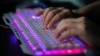 FILE - A member of a group of hackers uses his computer at the group's office in Dongguan, China, Aug. 4, 2020. Hundreds of thousands of Rhode Island residents' personal and bank information were likely hacked by an international cybercriminal group, said state officials.