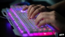 FILE - A member of a group of hackers uses his computer at the group's office in Dongguan, China, Aug. 4, 2020. Hundreds of thousands of Rhode Island residents' personal and bank information were likely hacked by an international cybercriminal group, said state officials.