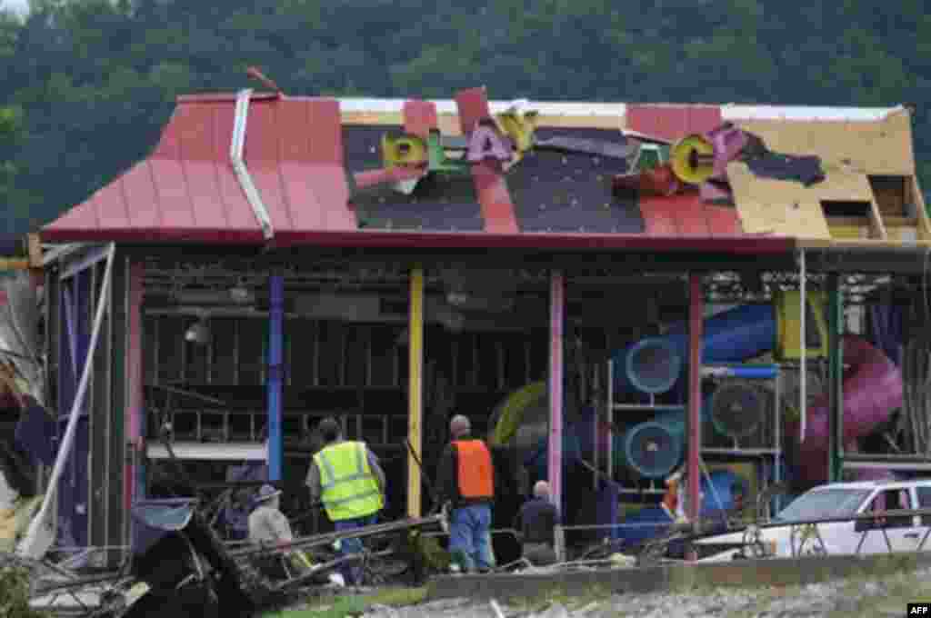 Workers search a McDonald's restaurant in Ringgold, Ga. Thursday, April 28, 2011, after a tornado slammed into the area Wednesday. Seven people were killed in Georgia's Catoosa County, including Ringgold, where a suspected tornado flattened about a dozen 