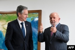 FILE — Brazil's President Luiz Inacio Lula da Silva (L) gives the thumbs up next to US Secretary of State Antony Blinken before a meeting at Planalto Palace in Brasilia on February 21, 2024.