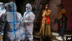 Health workers screen residents for COVID-19 symptoms at Dharavi, one of Asia's biggest slums, in Mumbai, India, Aug. 3, 2020. India is the third hardest-hit country by the pandemic in the world, after the United States and Brazil.