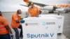 FILE - Workers take care of the shipment of Russia's Sputnik V vaccine at the airport in Caracas, Venezuela, March 29, 2021.