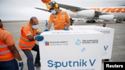 FILE - Workers take care of the shipment of Russia's Sputnik V vaccine at the airport in Caracas, Venezuela, March 29, 2021.