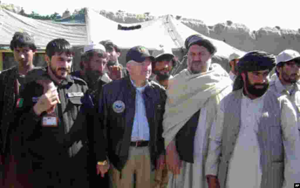 Secretary Gates poses for a photo with village elders in Tabin, March 8, 2011