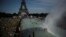 FILE - People cool off in the fountains of the Trocadero gardens, in front of the Eiffel Tower, in Paris, June 28, 2019. 