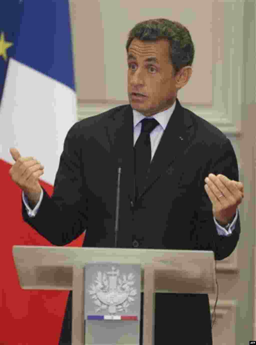 France's President Nicolas Sarkozy, right, gestures as he speaks during joint press conference with German Chancellor Angela Merkel at the Elysee Palace, Tuesday Aug. 16, 2011. (AP Photo/Michel Euler)