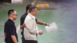 This picture taken and released by Taiwans Central News Agency (CNA) on September 5, 2024 shows ex-Taipei mayor and former presidential candidate Ko Wen-je being led to a police car to be taken to a detention centre in Taipei. Ko was detained on September 5 for alleged corruption after a Taiwanese court reversed a decision to release him,