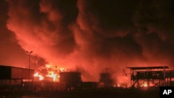 FILE - Oil tanks burn at the port in Hodeidah, Yemen, July 20, 2024. The Israeli army said it has struck several Houthi targets in western Yemen following a fatal drone attack by the rebel group in Tel Aviv the previous day.