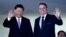 China's President Xi Jinping, left, and Brazil's President Jair Bolsonaro wave to reporters upon Xi's arrival for a bilateral meeting on the sidelines of the 11th BRICS Summit, at Itamaraty Palace, in Brasilia, Brazil, Nov. 13, 2019.