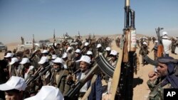 FILE - Houthi fighters march during a rally of support for the Palestinians in the Gaza Strip and against the U.S. strikes on Yemen outside Sanaa on January 22, 2024