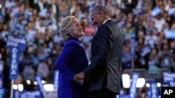 President Barack Obama, right, talks with Democratic presidential candidate Hillary Clinton, left, following Obama's speech at the Democratic National Convention in Philadelphia, Wednesday, July 27, 2016. (AP Photo/Susan Walsh)