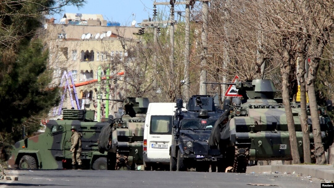 FILE - Military and police armored vehicles are parked in Baglar district, which is partially under curfew, in the Kurdish-dominated southeastern city of Diyarbakir, Turkey, March 17, 2016. The Turkish military says its warplanes have carried out airstrikes on Kurdish rebel positions along the border in northern Iraq on March 23, 2016..