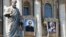 The tapestries of Roman Catholic Archbishop Oscar Romero, left, and Pope Paul VI hang from a balcony of the facade of St. Peter's Basilica at the Vatican, Oct. 13, 2018. Pope Francis will canonize two of the most important and contested figures of the 20th-century Catholic Church Sunday.