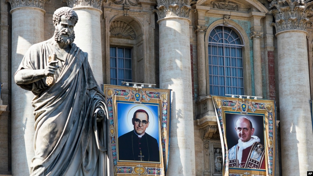 Permadani dinding Uskup Agung Katolik Roma Oscar Romero, kiri, dan Paus Paulus VI dipasang di balkon Basilika Santo Petrus di Vatikan, 13 Oktober 2018. Paus Fransiskus akan melakukan kanoninasi dua tokoh paling kontroversial dalam Gereja Katolik Roma pada abad 20.