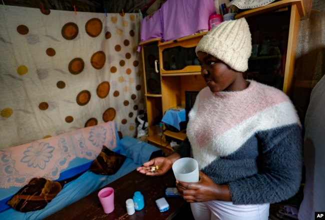 FILE - Idah Musimbi, 16, who contracted HIV at birth, takes PEPFAR-supplied antiretroviral pills in Nairobi, Kenya, on Aug. 16, 2023. Funds for PEPFAR, an acclaimed anti-HIV program, were apparently among those included in a U.S. aid freeze, Jan. 24, 2025.