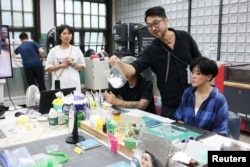 Arthur Huang, founder of Miniwiz, the company that runs Trash Kitchen, holds a jar of plastic waste that will be turned into frames of sunglasses at his workshop in Taipei, Taiwan, August 19, 2024. (REUTERS/Ann Wang)