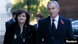 FILE - Former British Prime Minister Tony Blair and his wife Cherie arrive for the annual Remembrance Sunday ceremony at the Cenotaph, in central London, November 2013.