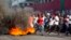 Demonstrators run away during a protest to demand the resignation of President Jovenel Moise and an explanation of how Petro Caribe funds have been used by the current and past administrations, in Port-au-Prince, Haiti, Feb. 9, 2019.