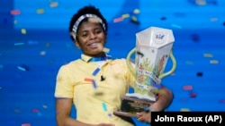 Zaila Avant-garde celebrates with the championship trophy after winning the finals of the 2021 Scripps National Spelling Bee, July 8, 2021.