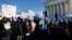 People participate in a rally at the Supreme Court in Washington, Jan. 11, 2016, as the court heard arguments in the 'Friedrichs v. California Teachers Association' case. 