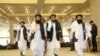 FILE - Members of Afghanistan's Taliban delegation arrive for the signing of an agreement between the Taliban and U.S. officials, in Doha, Qatar, Feb. 29, 2020.