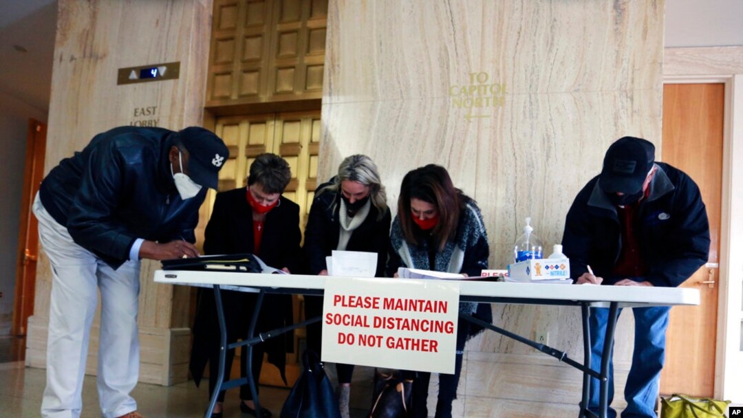 Five self-proclaimed GOP electors hold an unofficial ceremony to endorse the reelection of Donald Trump, Dec. 14, 2020, in the Capitol in Santa Fe, N.M. The meeting occurred as the official electors cast the state's five electoral votes for Joe Biden in a closed meeting upstairs.
