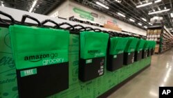 Reusable shopping bags are displayed inside an Amazon Go Grocery store set to open soon in Seattle's Capitol Hill neighborhood, Feb. 21, 2020.