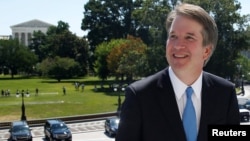 With the U.S. Supreme Court building in the background, Supreme Court nominee judge Brett Kavanaugh arrives prior to meeting with Senate Majority Leader Mitch McConnell on Capitol Hill in Washington, July 10, 2018. 