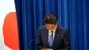 Japanese Prime Minister Shinzo Abe bows during a press conference announcing his resignation, at the prime minister's official residence in Tokyo, Japan, Aug. 28, 2020.