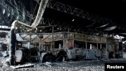 Destroyed buses are seen after a fire in a parking lot in San Cristobal, Venezuela May 17, 2017. 